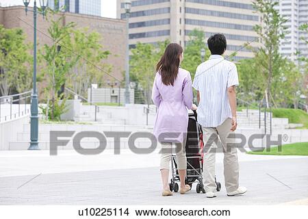 Parents Pushing Buggy View Large Photo Image Picture - Parents Pushing Buggy. Fotosearch