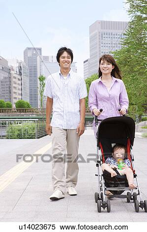 Stock Photography - Parents Pushing Buggy. Fotosearch