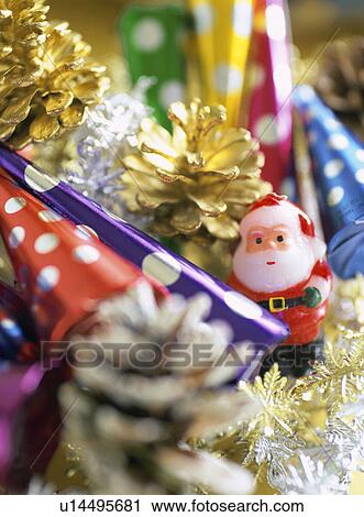 Party poppers, Santa Claus candle and pine cones View Large Photo Image Stock Image - Party poppers, Santa Claus candle and pine cones. Fotosearch