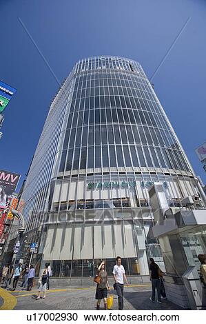 Stock Image - Pedestrians Outside Multistory Building. Fotosearch