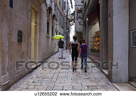 Pedestrians Walking Down Alley Near Diocletian Royal Palace View Large Photo Image Stock Image - Pedestrians Walking Down Alley Near Diocletian Royal Palace. Fotosearch
