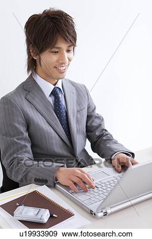 Portrait of businessman using laptop View Large Photo Image Stock Photo - Portrait of businessman using laptop. Fotosearch