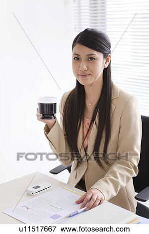 Portrait of businesswoman sitting at her desk View Large Photo Image Stock Photo - Portrait of businesswoman sitting at her desk. Fotosearch