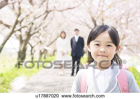 Portrait of girl with parents in background View Large Photo Image Stock Image - Portrait of girl with parents in background. Fotosearch
