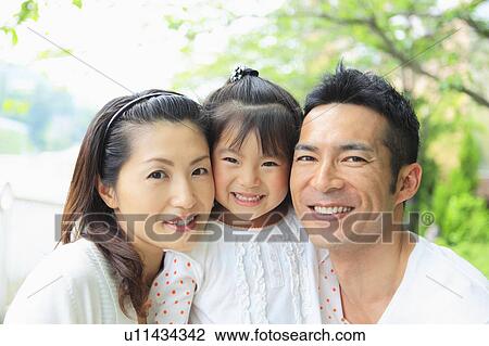 Stock Image - Portrait of Parents and Daughter. Fotosearch