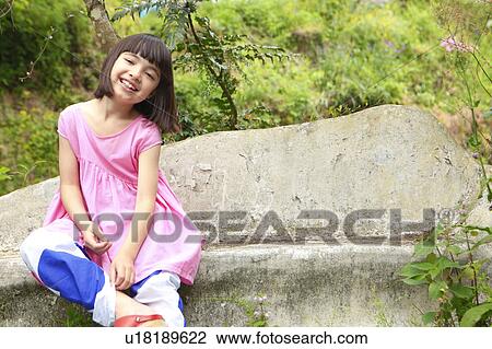 Stock Image - Portrait of Young Girl Sitting On Bench. Fotosearch