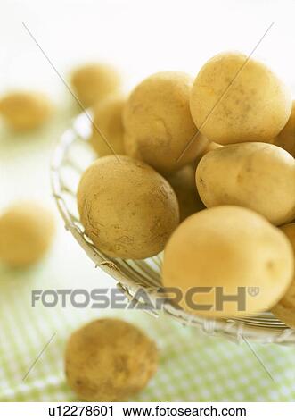 Stock Image - Potatoes in a basket. Fotosearch