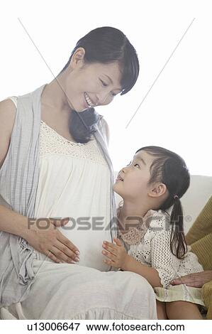 Stock Photo - Pregnant Mother and Daughter. Fotosearch