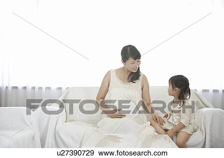 Stock Photo - Pregnant Mother and Daughter Talking. Fotosearch