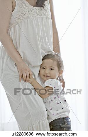 Stock Photograph - Pregnant Mother and Her Young Daughter. Fotosearch