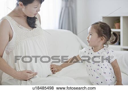 Pregnant Mother Talking to Daughter View Large Photo Image Stock Photo - Pregnant Mother Talking to Daughter. Fotosearch