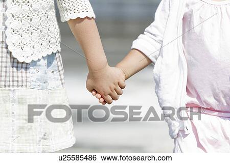 Stock Photograph - Sisters Holding Hands. Fotosearch