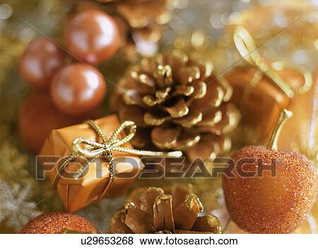 Stock Photo - Small gifts, pine cones and small apples. Fotosearch