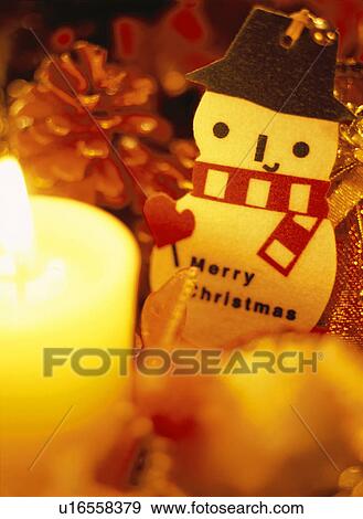 Stock Photo - Snowman ornament and candle. Fotosearch