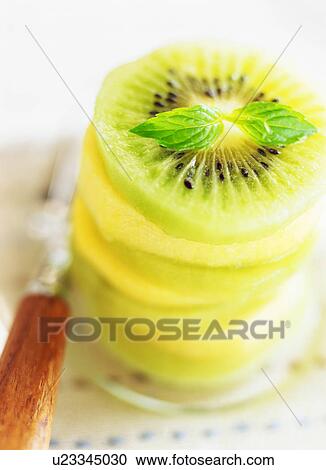 Stack of sliced kiwi fruits View Large Photo Image Stock Image - Stack of sliced kiwi fruits. Fotosearch
