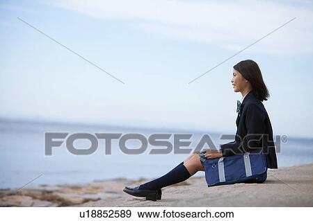 Teenage Schoolgirl Sitting on Steps at Coast View Large Photo Image Stock Photo - Teenage Schoolgirl Sitting on Steps at Coast. Fotosearch