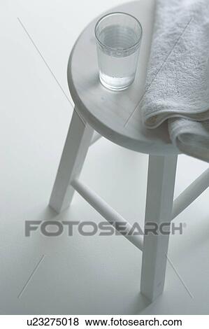 Stock Photo - Towel and Drinking Glass on Stool. Fotosearch