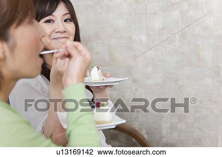 Two Female Friends Eating Cake View Large Photo Image Stock Image - Two Female Friends Eating Cake. Fotosearch