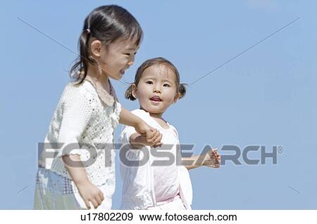 Two Girls Walking in Hand in Hand View Large Photo Image Stock Photo - Two Girls Walking in Hand in Hand. Fotosearch