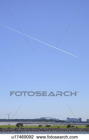 Stock Image - Vapour Trail Above Kasai Rinkai Park. Fotosearch