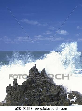 Stock Photo - Wave Splashing Against Rocks. Fotosearch