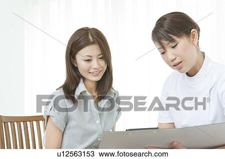 Stock Image - Woman talking to a beautician. Fotosearch