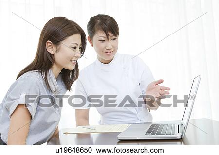 Stock Image - Woman talking to a beautician. Fotosearch