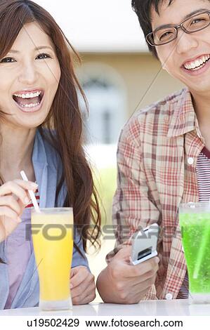Stock Photo - Young Couple Having Juice. Fotosearch
