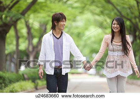 Young couple holding hands View Large Photo Image Stock Image - Young couple holding hands. Fotosearch