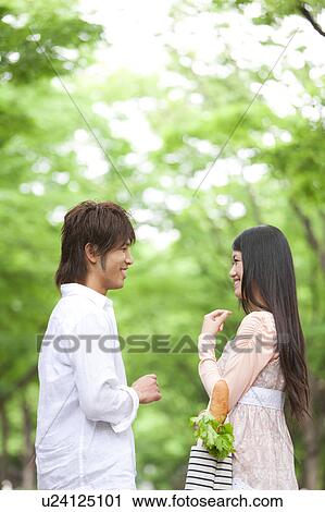 Young couple standing face to face View Large Photo Image Stock Image - Young couple standing face to face. Fotosearch