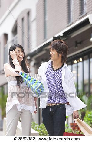 Stock Image - Young couple with shopping bags. Fotosearch