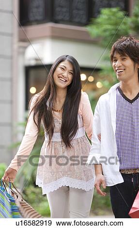 Stock Photo - Young couple with shopping bags. Fotosearch