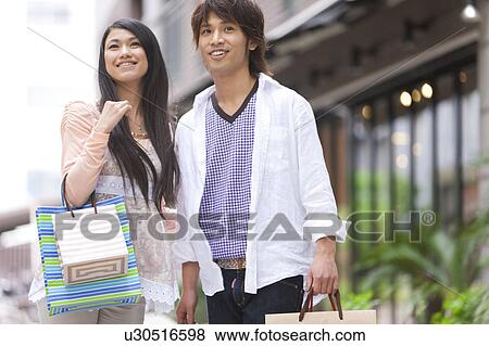 Young couple with shopping bags View Large Photo Image Stock Photo - Young couple with shopping bags. Fotosearch