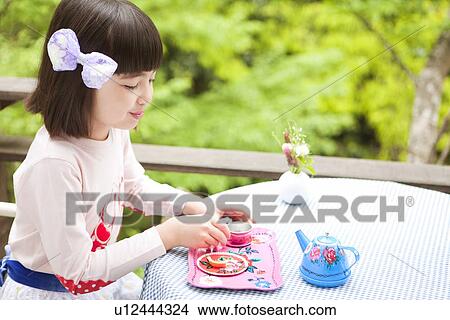 Picture - Young Girl Eating Biscuit. Fotosearch