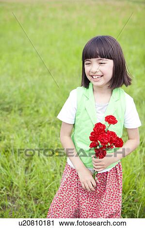Stock Image - Young Girl Holding Bunch of Flowers. Fotosearch
