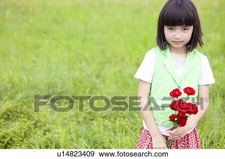 Stock Photo - Young Girl Holding Bunch of Flowers. Fotosearch