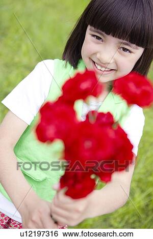 Stock Photograph - Young Girl Holding Bunch of Flowers. Fotosearch