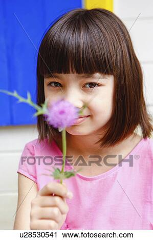 Stock Image - Young Girl Holding Flower. Fotosearch