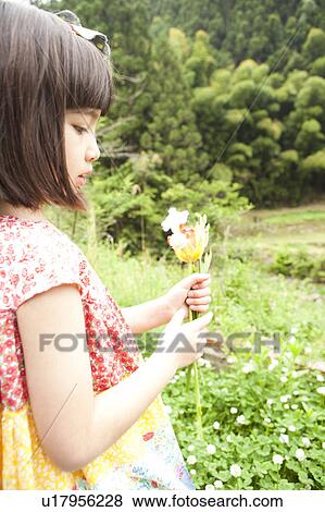 Stock Photo - Young Girl Holding Flowers. Fotosearch