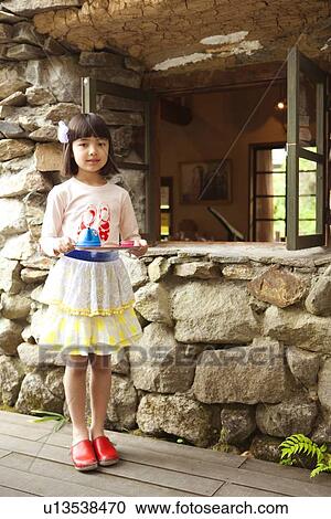 Stock Image - Young Girl Playing with Toy Pots. Fotosearch