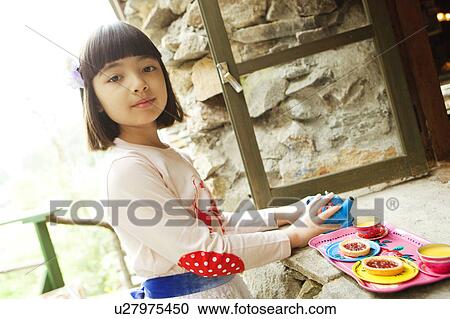 Stock Image - Young Girl Playing with Toy Pots. Fotosearch