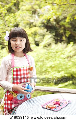 Stock Photography - Young Girl Playing with Toy Pots. Fotosearch
