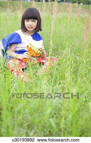 Young Girl Sitting in Field View Large Photo Image Stock Image - Young Girl Sitting in Field. Fotosearch