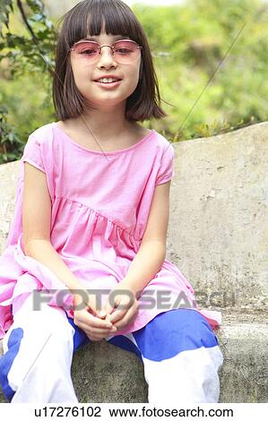 Stock Image - Young Girl Sitting on Bench. Fotosearch