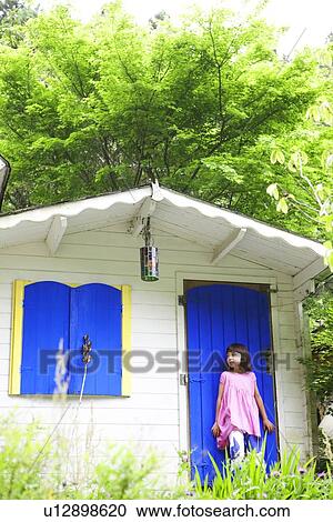 Young Girl Standing Outside Playhouse View Large Photo Image Stock Image - Young Girl Standing Outside Playhouse. Fotosearch