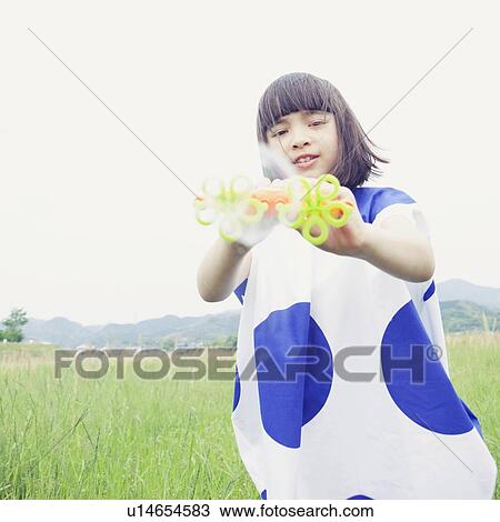 Stock Image - Young Girl with Bubble Wand. Fotosearch