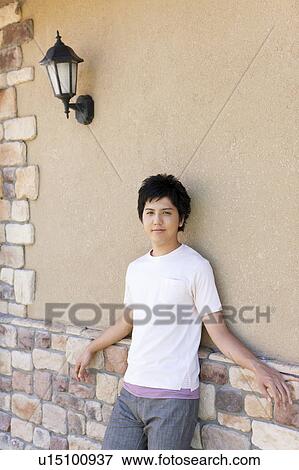 Young Man Leaning Against Beige Wall View Large Photo Image Stock Photo - Young Man Leaning Against Beige Wall. Fotosearch