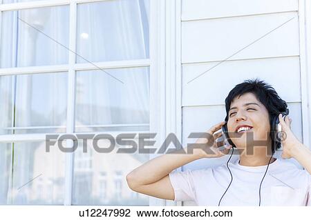 Stock Image - Young Man Listening to Headphones. Fotosearch