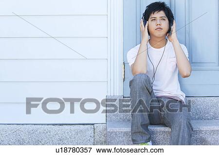 Young Man on Steps Listening to Music View Large Photo Image Stock Photo - Young Man on Steps Listening to Music. Fotosearch