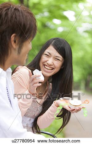 Young man proposing to girlfriend in a park View Large Photo Image Picture - Young man proposing to girlfriend in a park. Fotosearch